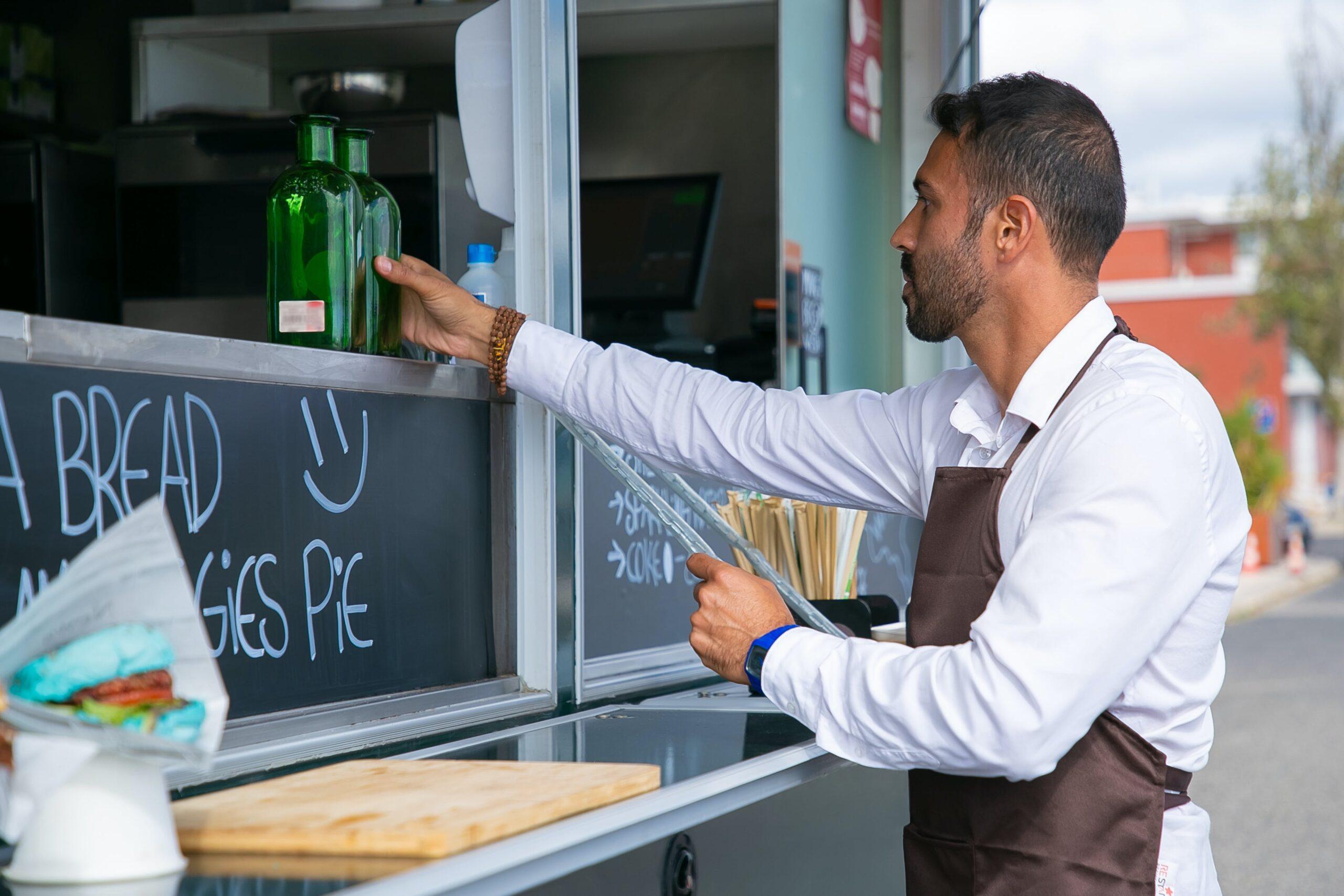 The owner of a food truck readies it for the day's business.