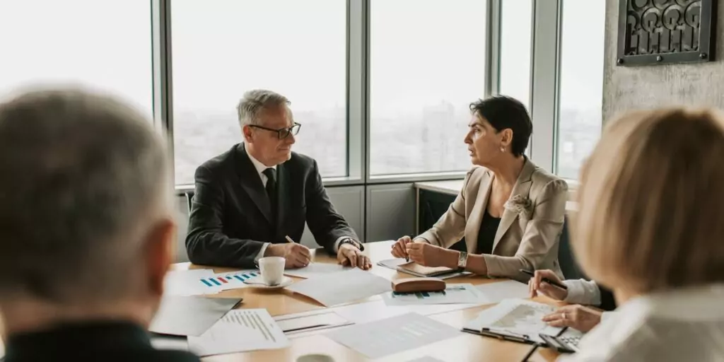 Two employees of a lender discuss a loan they're considering.